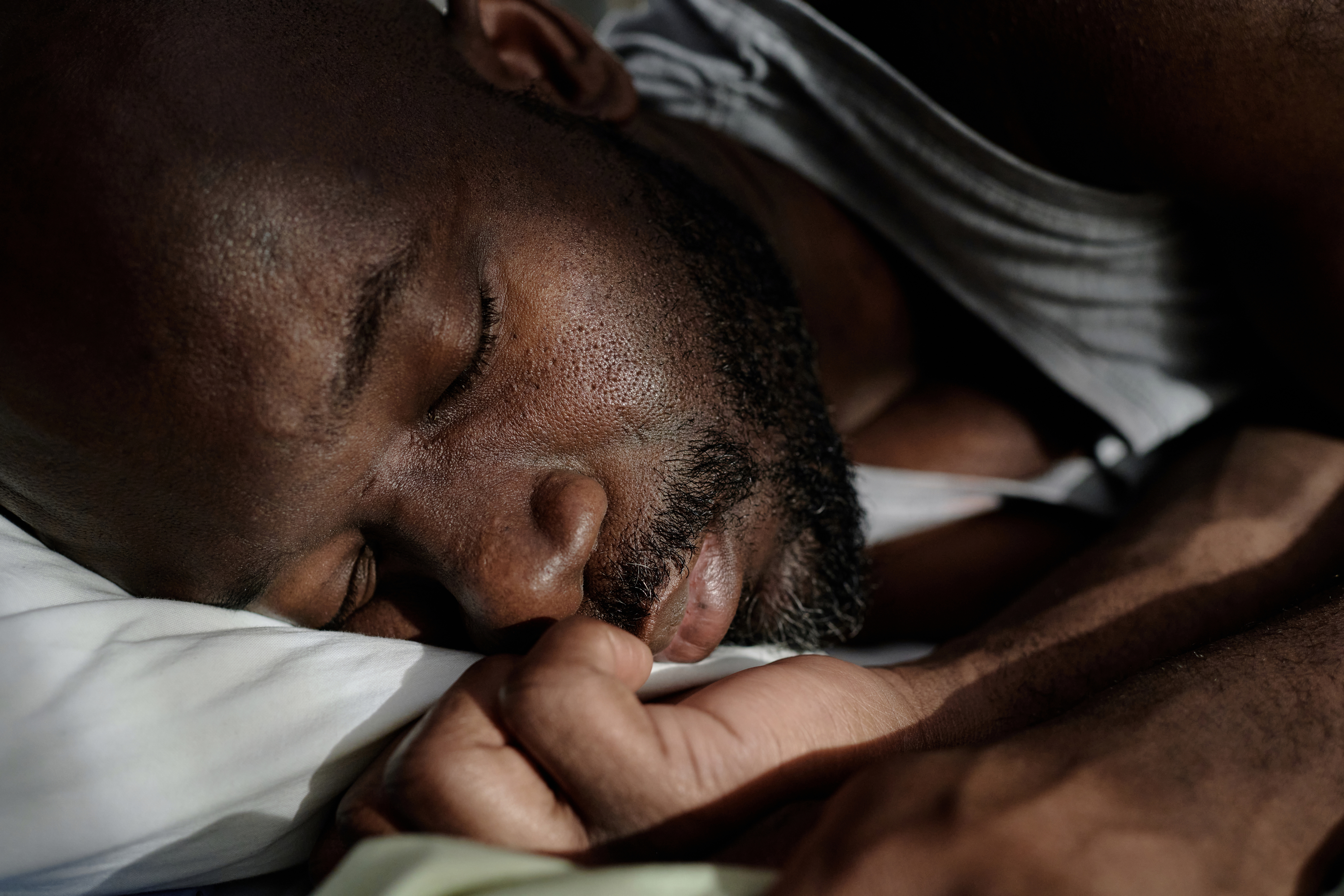 Man sleeping peacefully to illustrate the importance of restorative sleep for hormone balance and overall health.