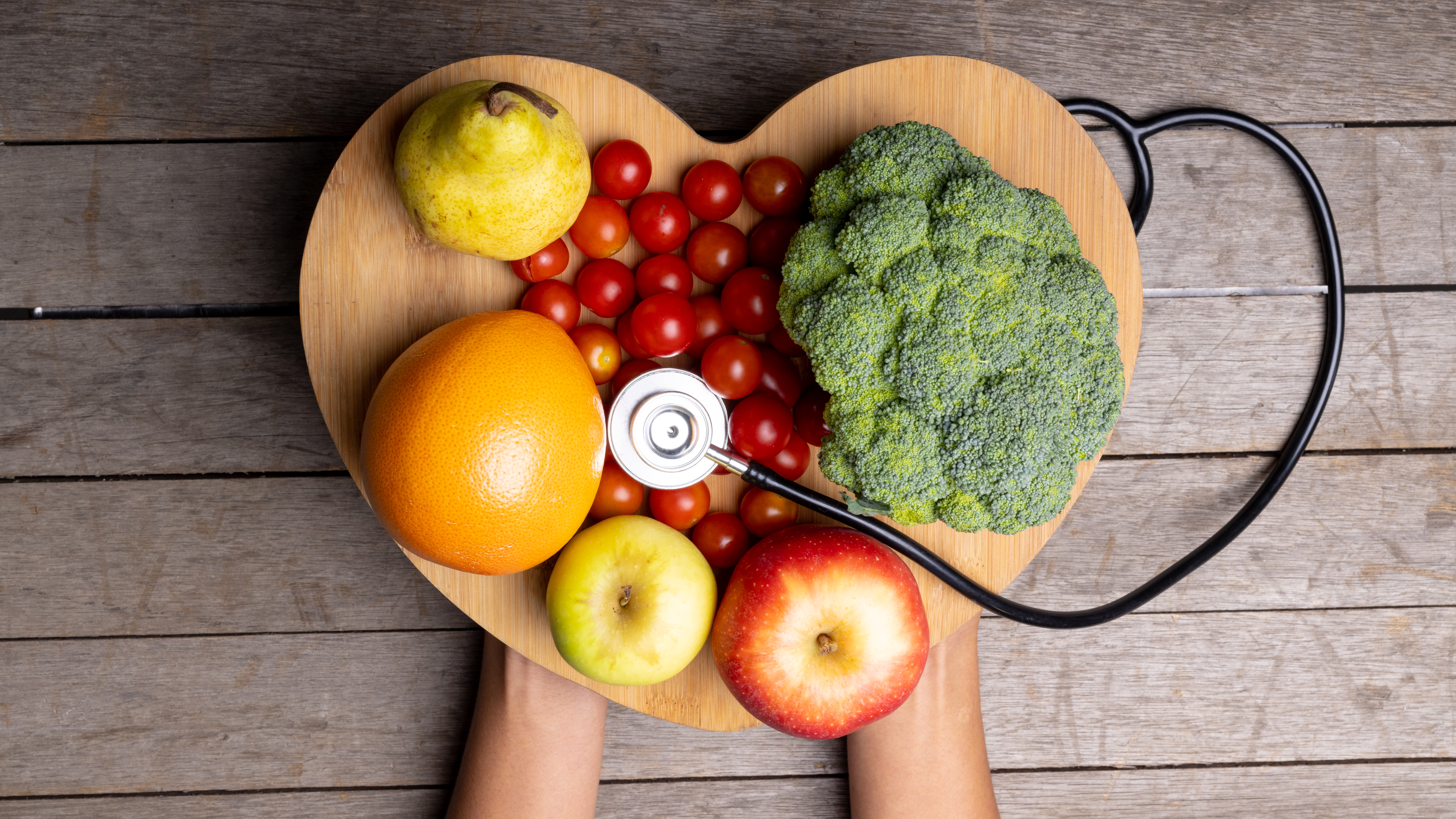 A plate of healthy foods on a platter resembling a heart, denoting the connection between metabolic function and cardiac health.